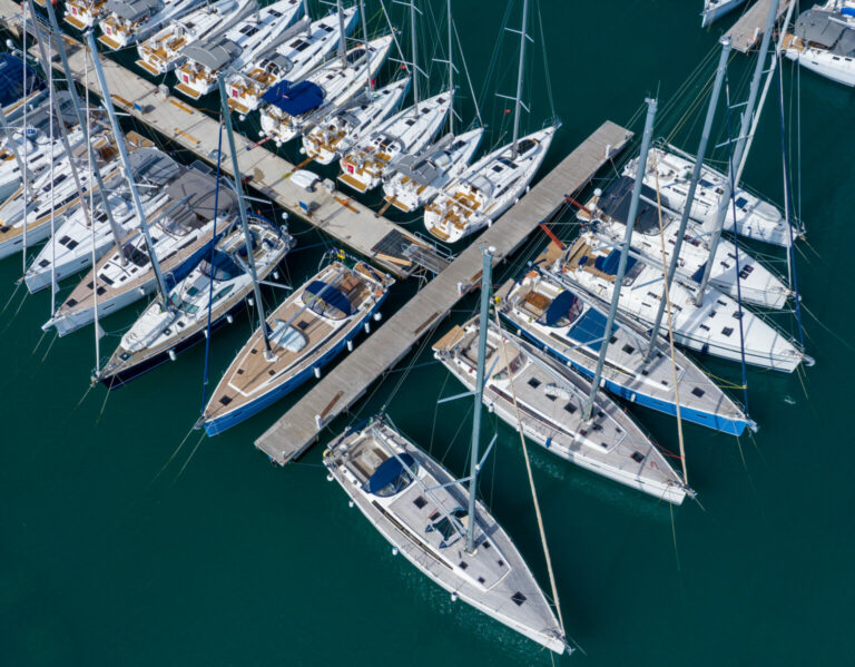 Aerial view of a lot of white boats and yachts moored in marina.